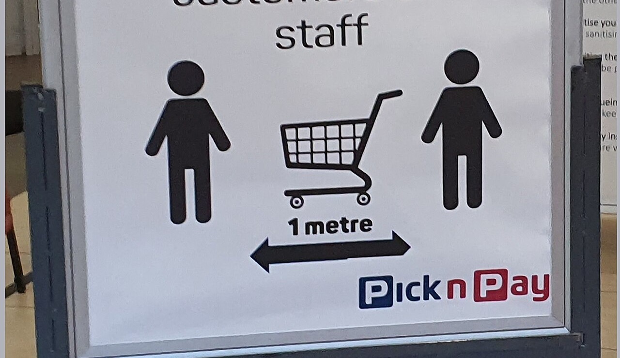 Pick n Pay store sign asking customers to keep 1 metre apart, with a shopping trolley pictogram and the Pick n Pay logo
