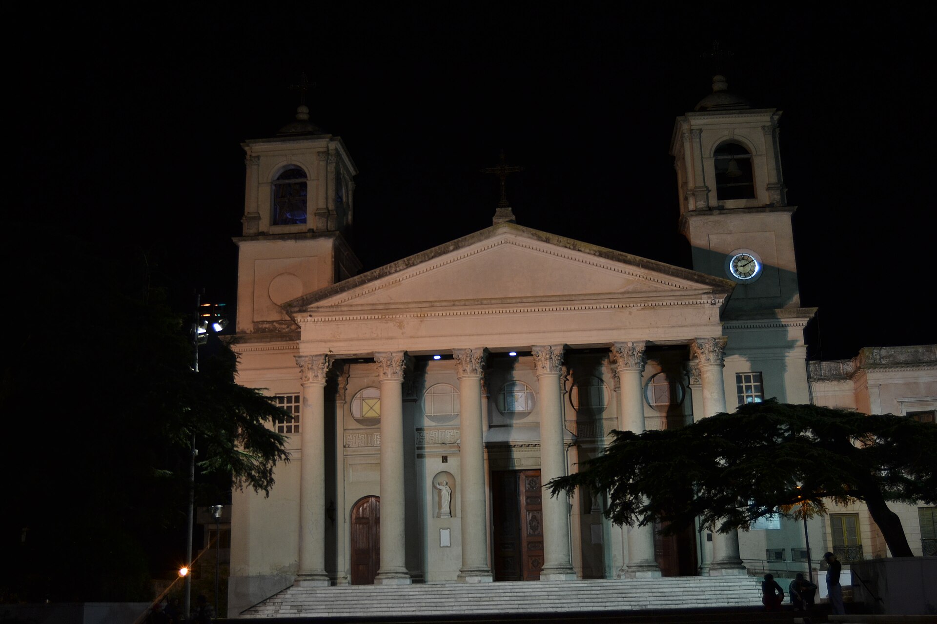 Night view of the columned facade and two bell towers of the basilica in Paysandu, Uruguay