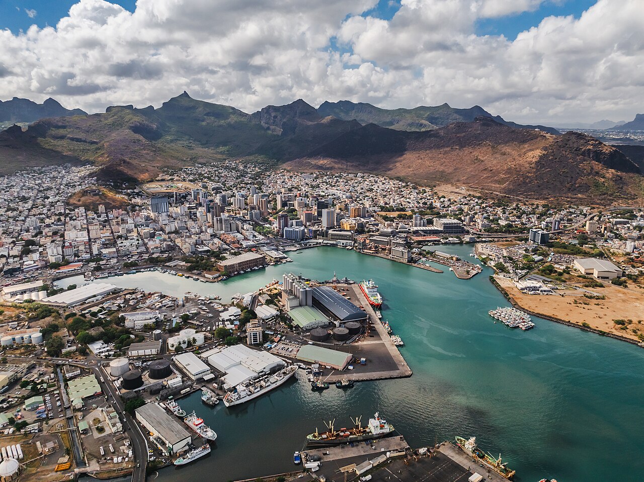 Aerial view of Port Louis, the capital of Mauritius, with its harbour and mountains behind.