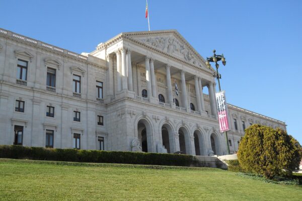 The Palácio de São Bento in Lisbon, seat of the Portuguese Parliament, with a white neoclassical façade and a lawn