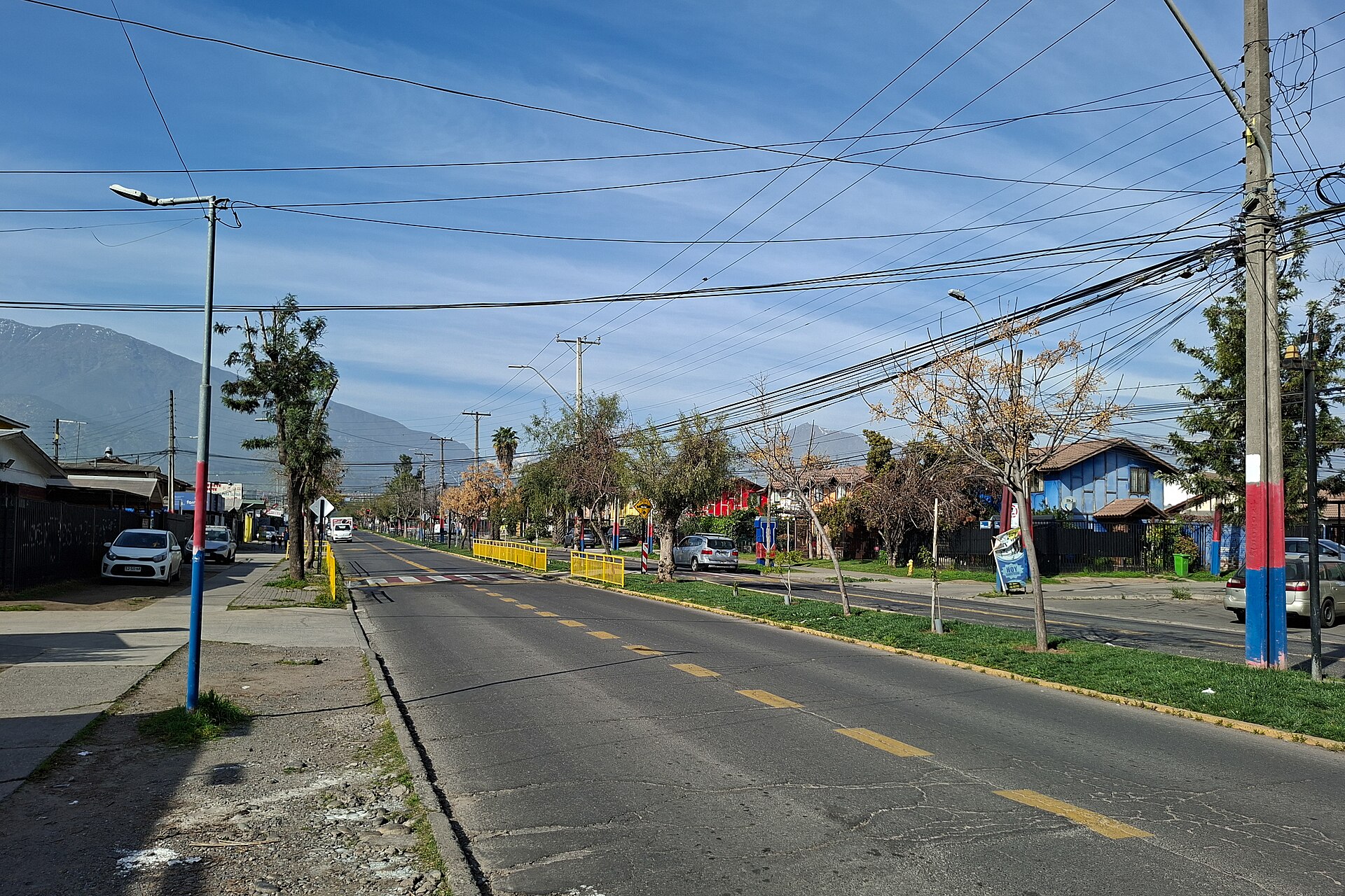 Avenida Gabriela Oriente, a residential street in Puente Alto with the Andes foothills behind