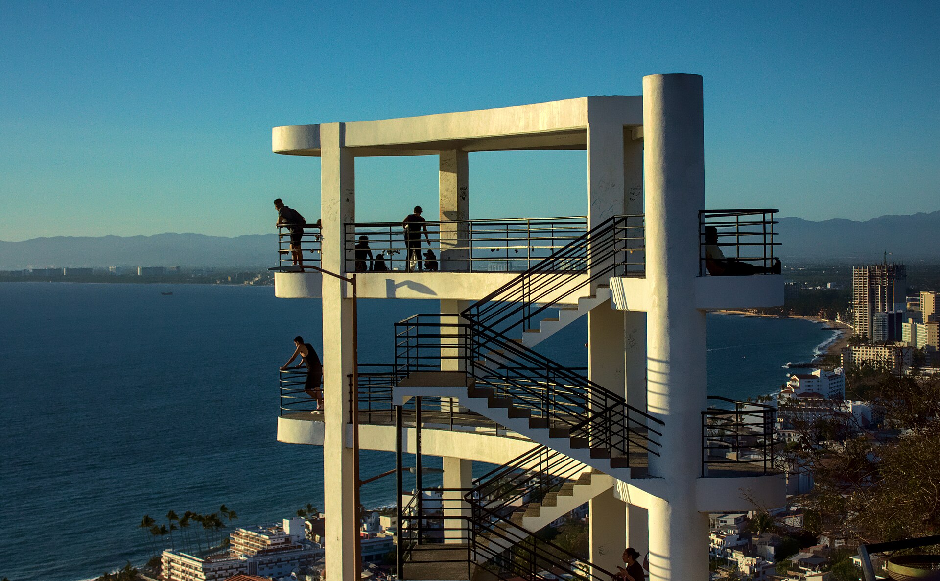 Puerto Vallarta travel guide: people on a white concrete lookout tower above the city with Banderas Bay behind