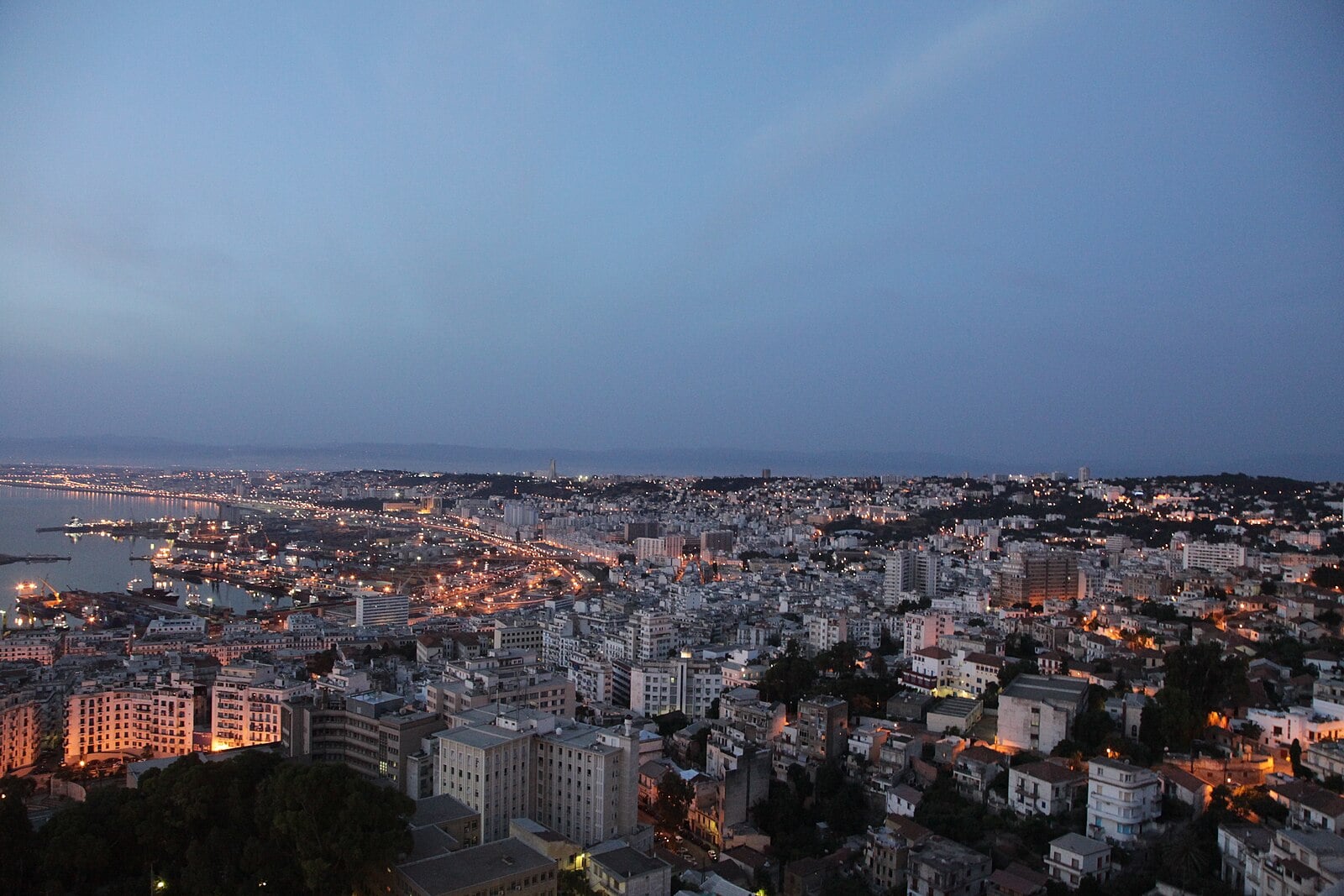 The Bay of Algiers and its port at dusk, seen from a hill above the city