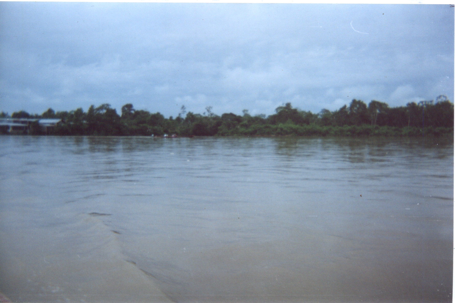 Wide stretch of the Putumayo River near Puerto Asís, Colombia, under a cloudy sky