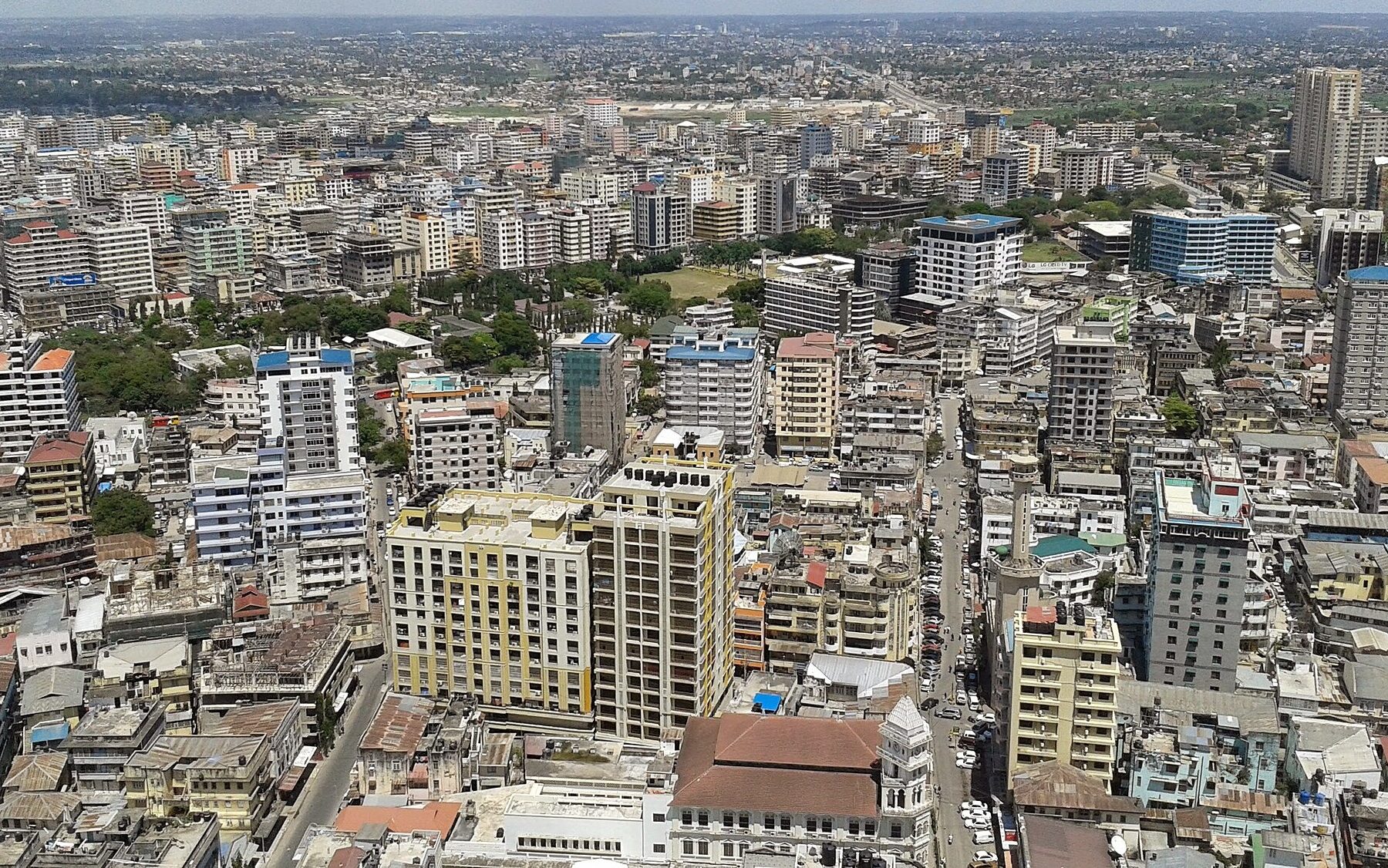 Aerial view over the dense business district of Dar es Salaam with mid-rise office and apartment buildings along busy streets