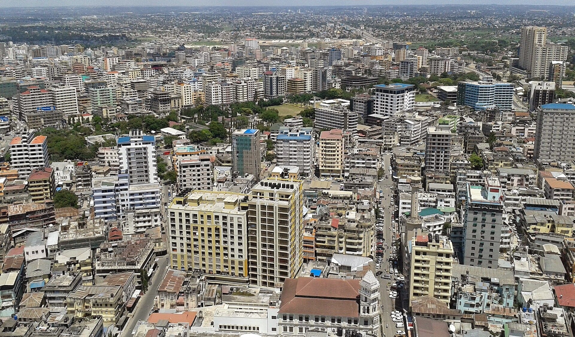 Aerial view over the dense business district of Dar es Salaam with mid-rise office and apartment buildings along busy streets