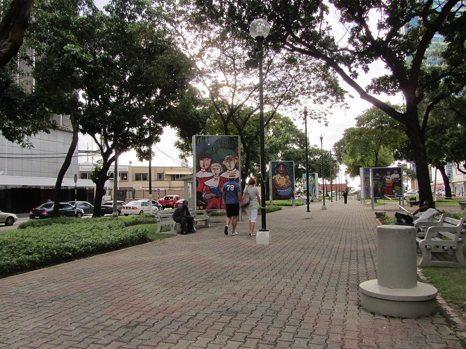 A tree-lined promenade with street art panels on Independence Square in Port of Spain, Trinidad and Tobago