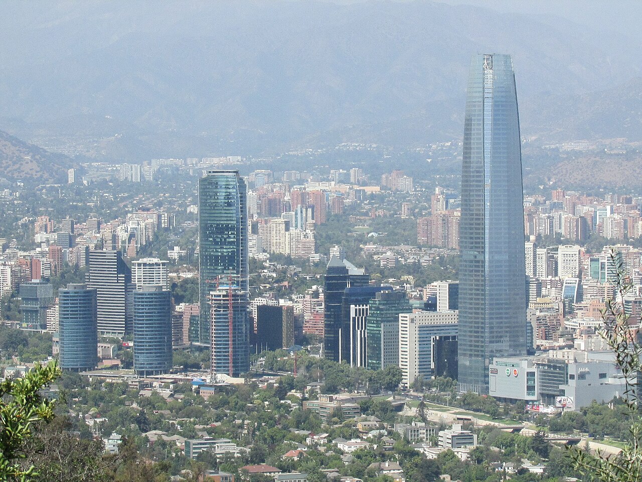 Glass towers of Santiago, Chile, with the Andes foothills behind