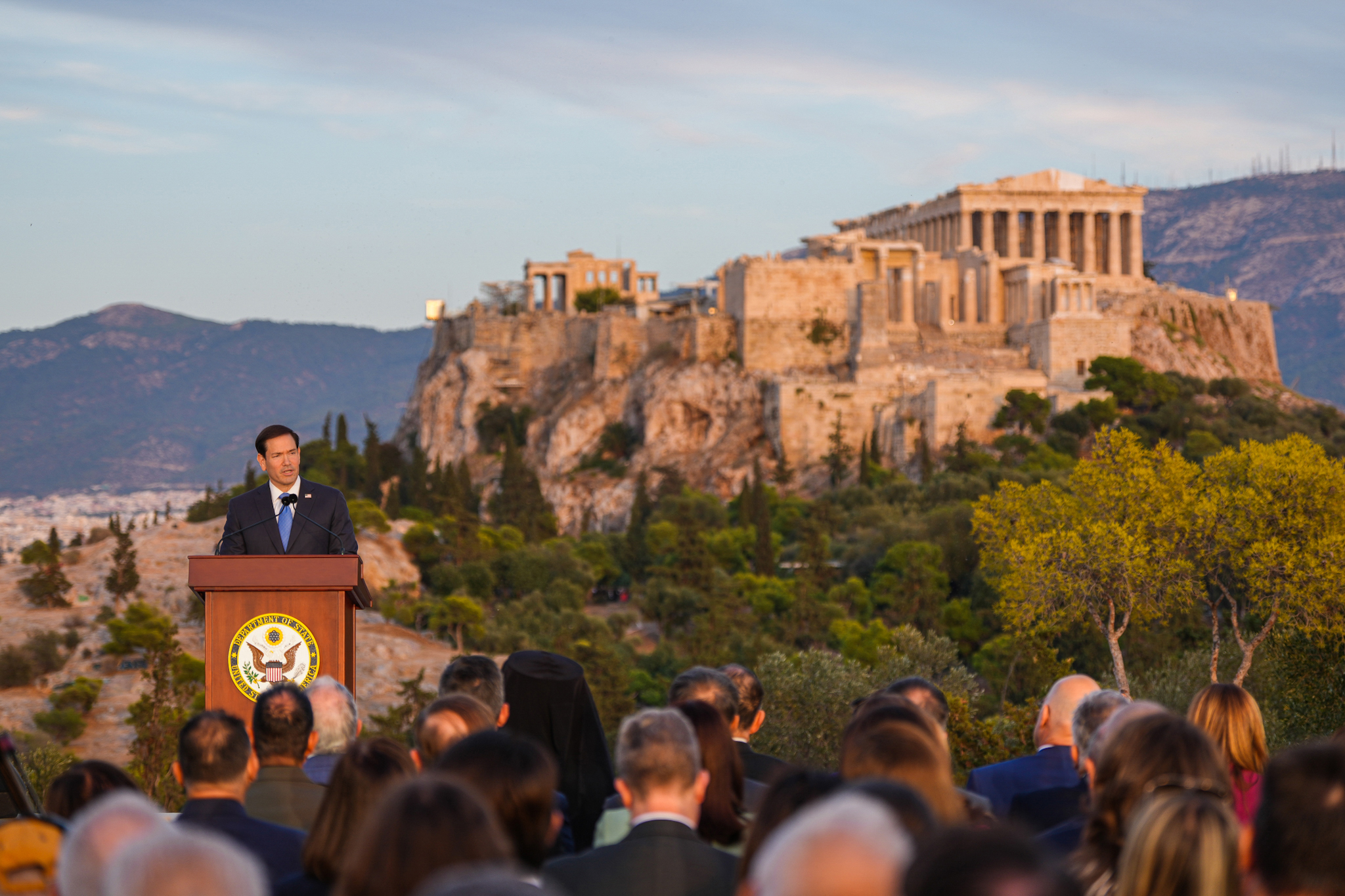 Guests listening to Marco Rubio on the Pnyx with the Acropolis in the background