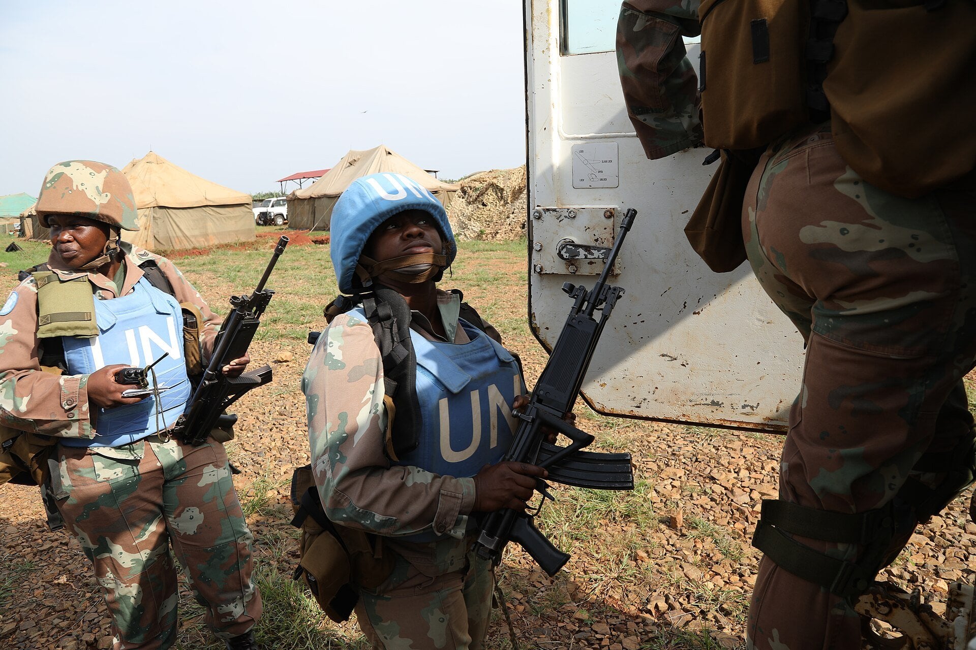South African women soldiers in UN helmets and vests with rifles beside a vehicle on a patrol near Beni in eastern DR Congo