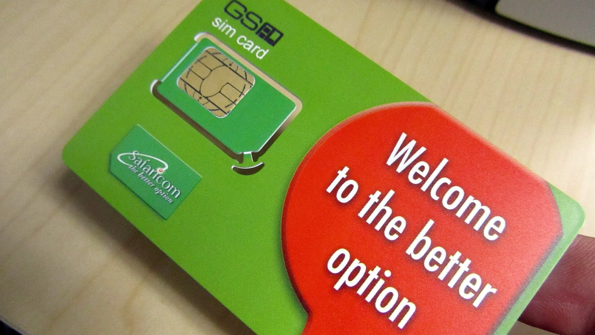 A green Safaricom SIM card held in a hand, with the words Welcome to the better option