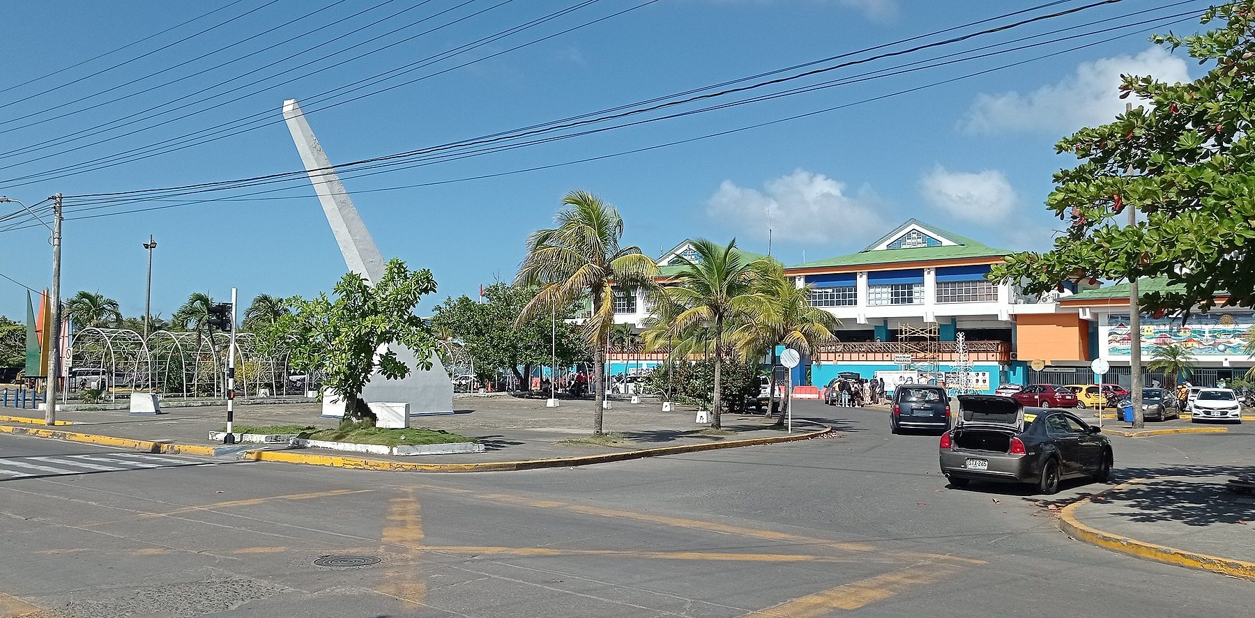 San Andrés airport terminal in Colombia with the white Navy veterans monument in front