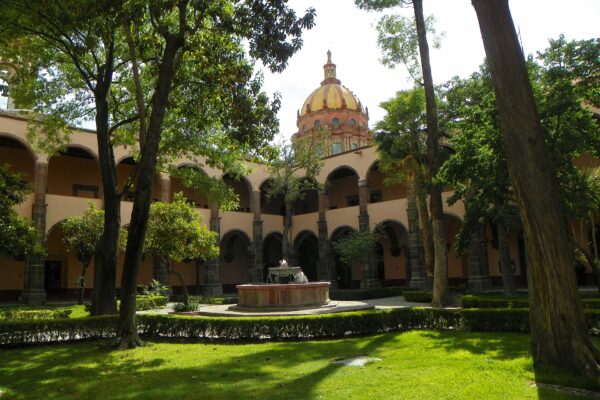 Arcaded cloister with a stone fountain at El Nigromante, San Miguel de Allende
