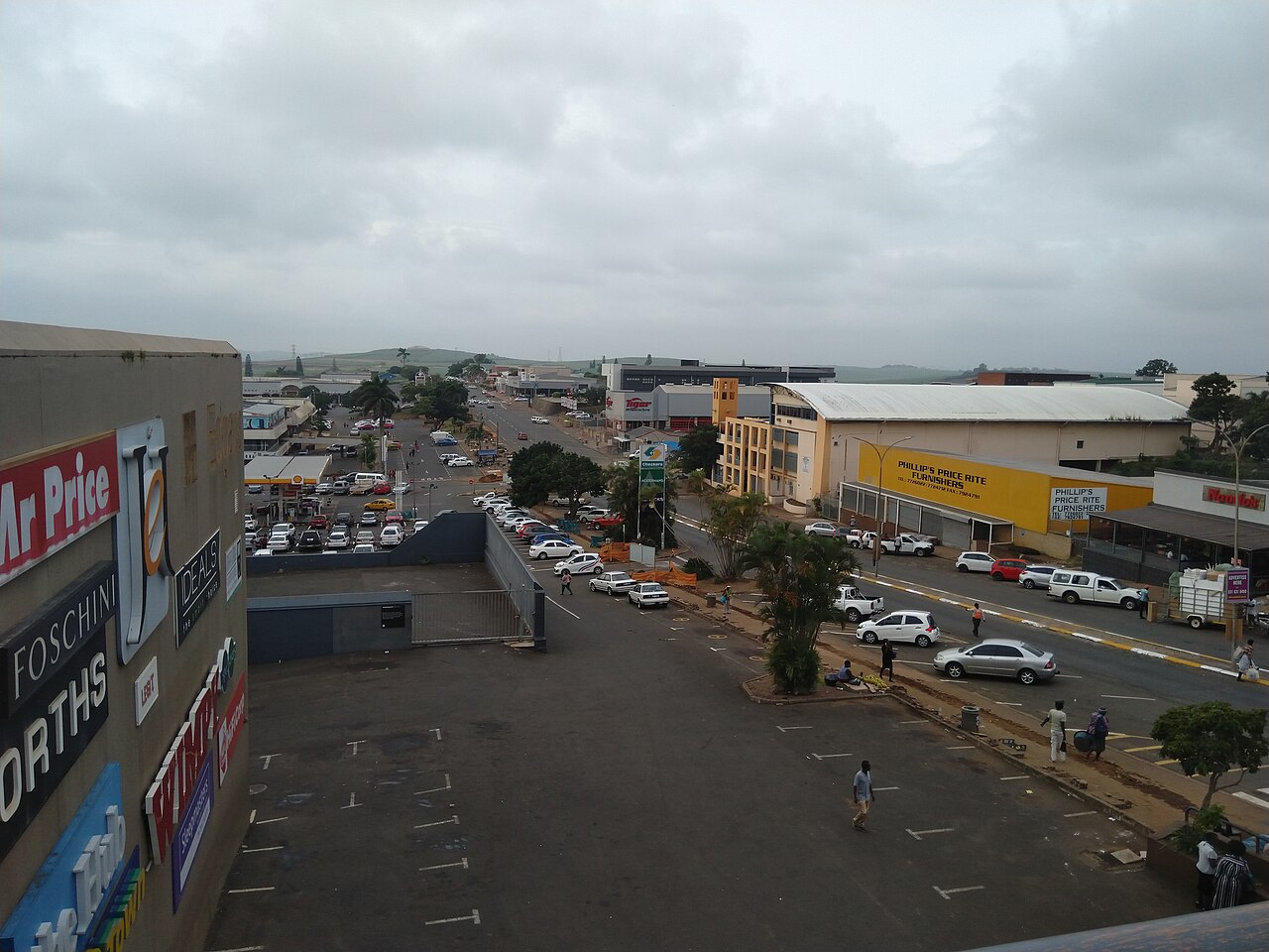 Shops, a car park and a main street in the town centre of Empangeni, South Africa