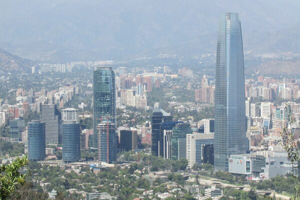 The Gran Torre Santiago skyscraper and office towers of Santiago, Chile, with hazy Andes foothills behind