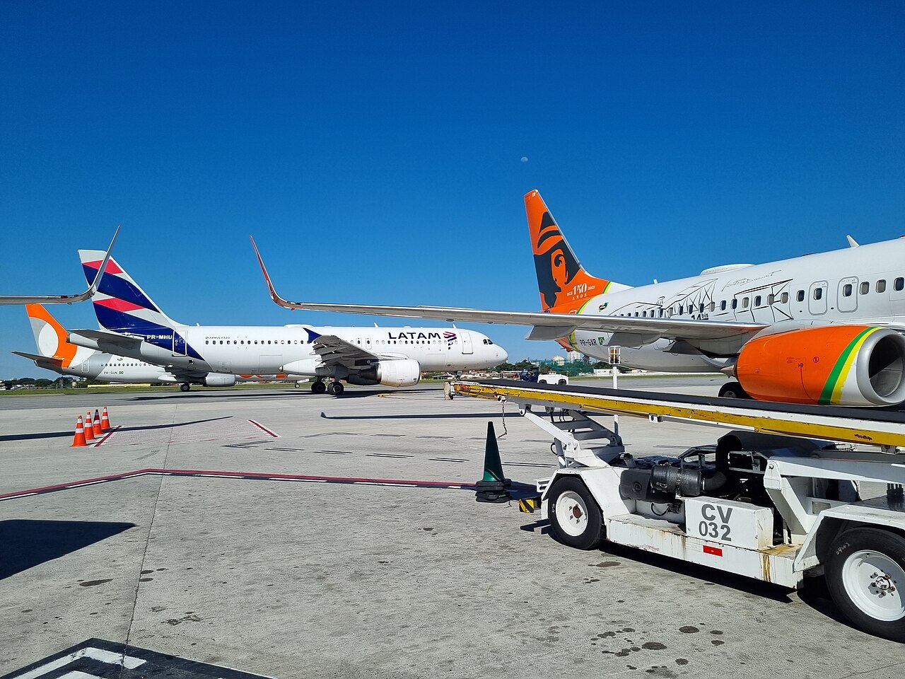 LATAM and Gol passenger jets on the apron at Congonhas Airport in São Paulo under a clear blue sky