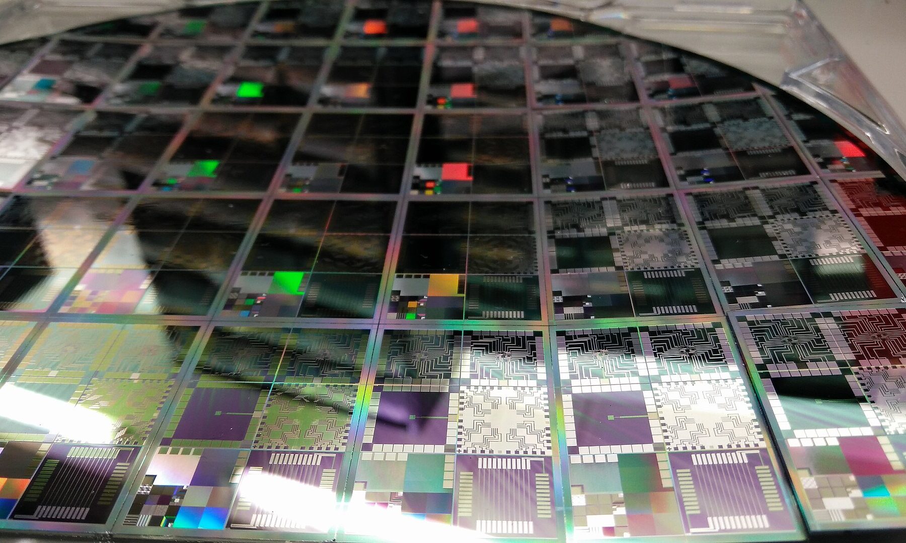 Close-up of a 12-inch semiconductor wafer with rows of microelectronic test chips