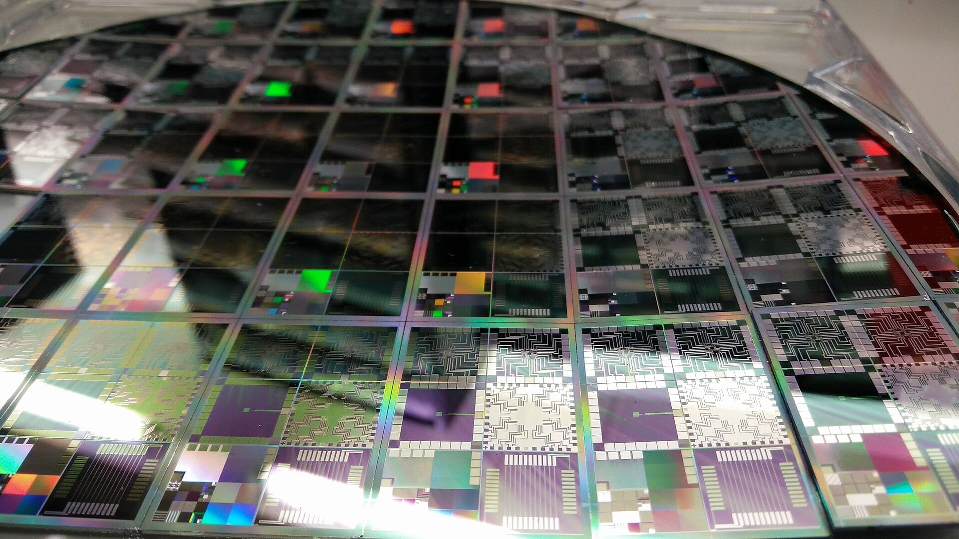 Close-up of a 12-inch semiconductor wafer with rows of microelectronic test chips