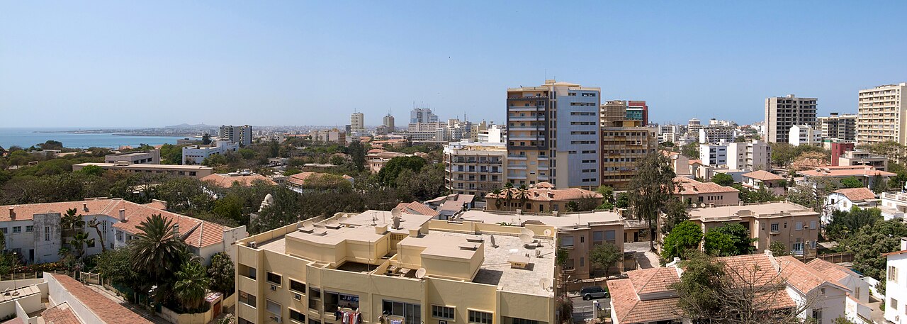 Rooftops and apartment blocks of central Dakar, Senegal, with the Atlantic Ocean on the left horizon