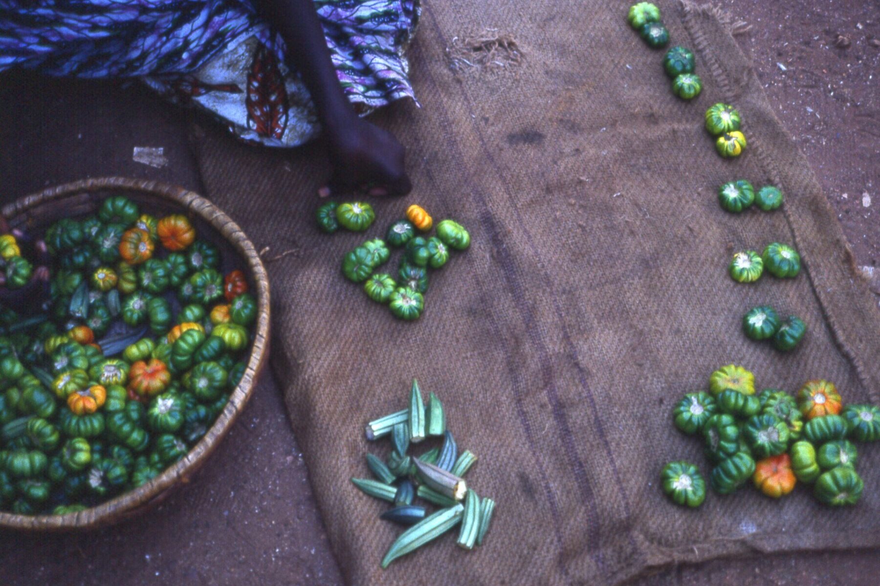 African eggplants and okra laid out for sale on sacking at a market in Kédougou, southeast Senegal