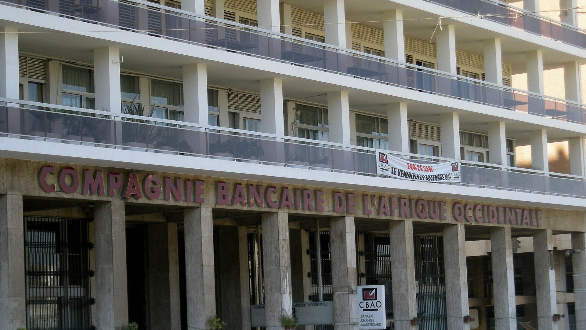 Front of the Compagnie Bancaire de l'Afrique Occidentale bank building on Place de l'Independance in Dakar with its name above the arcade