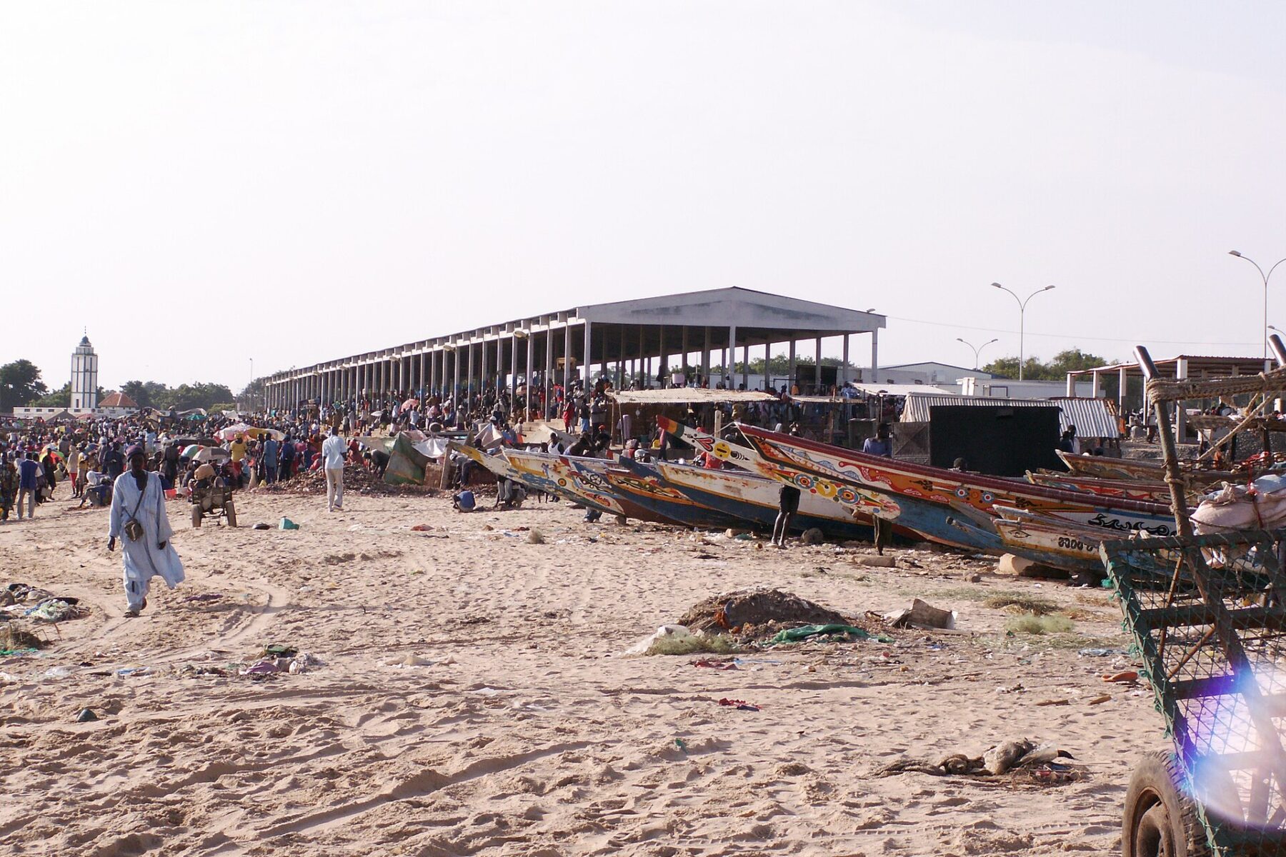 Fishing pirogues and the fish market on the beach at M’Bour, Senegal
