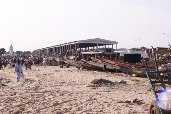 Fishing pirogues and the fish market on the beach at M’Bour, Senegal
