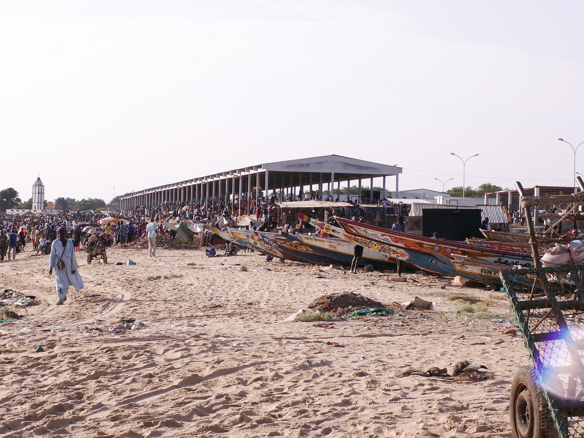 Fishing pirogues and the fish market on the beach at M’Bour, Senegal
