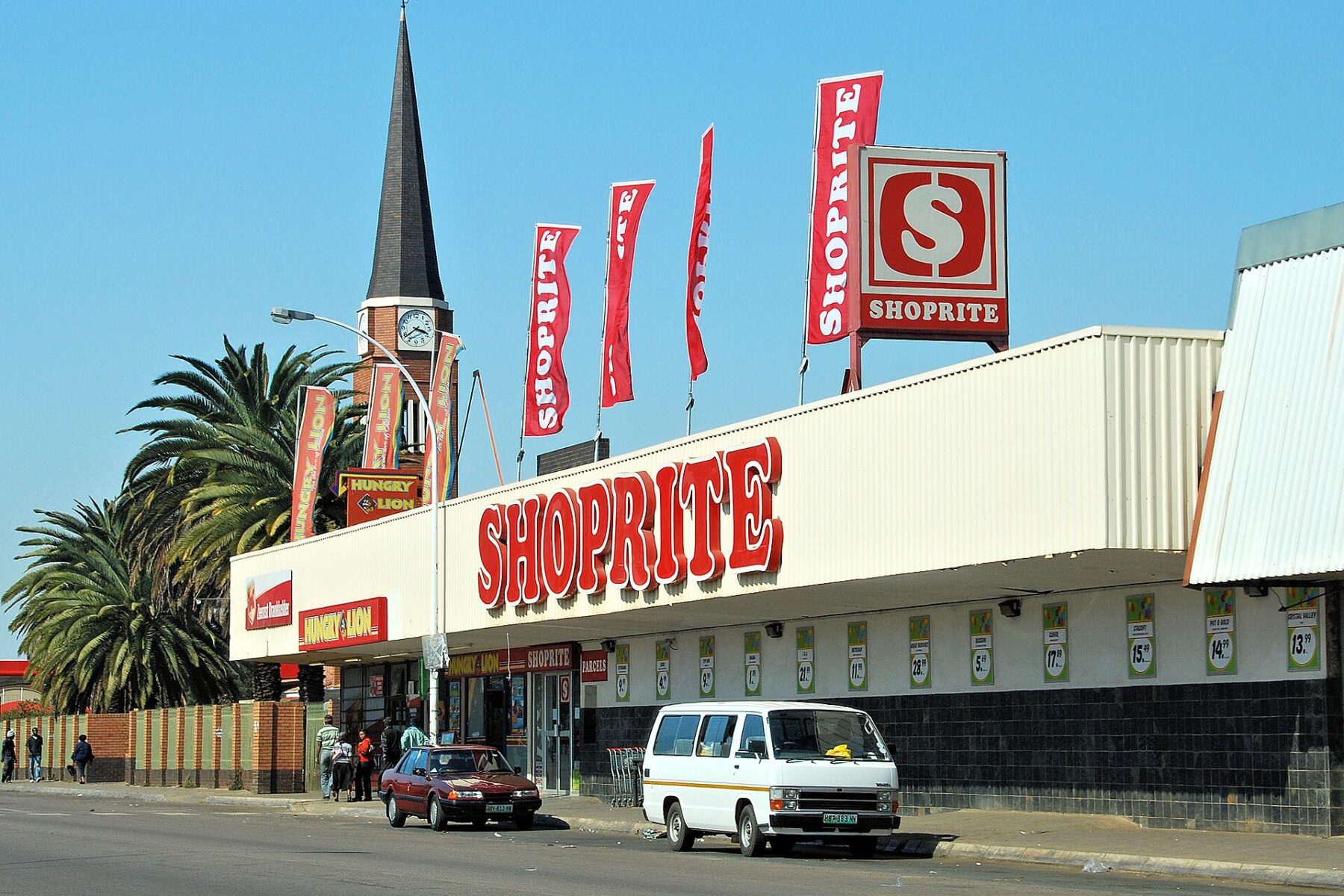 Shoprite supermarket with red signage and flags on a street in Zeerust, South Africa