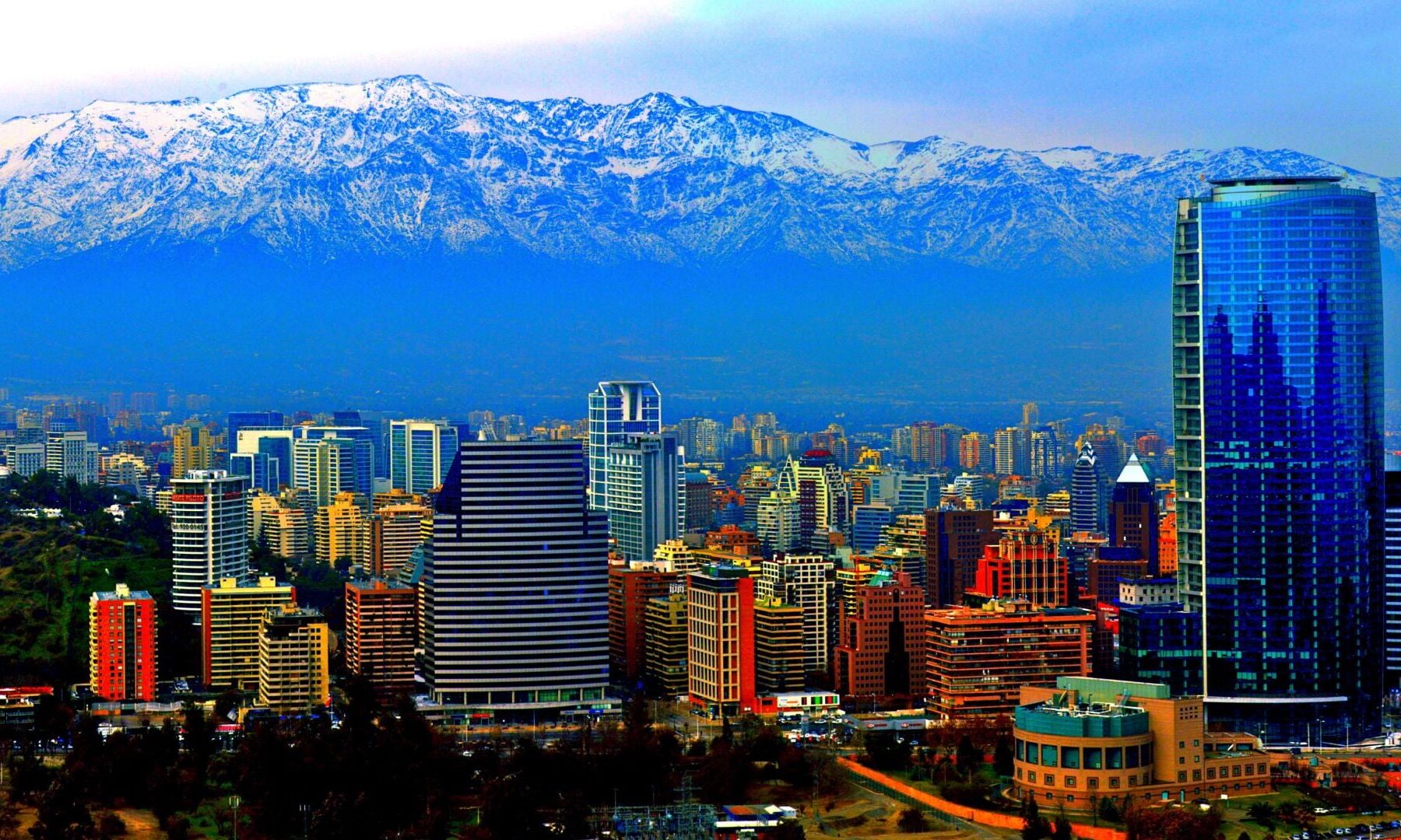 Skyline of Santiago, Chile, with glass towers in front of the snow-capped Andes.