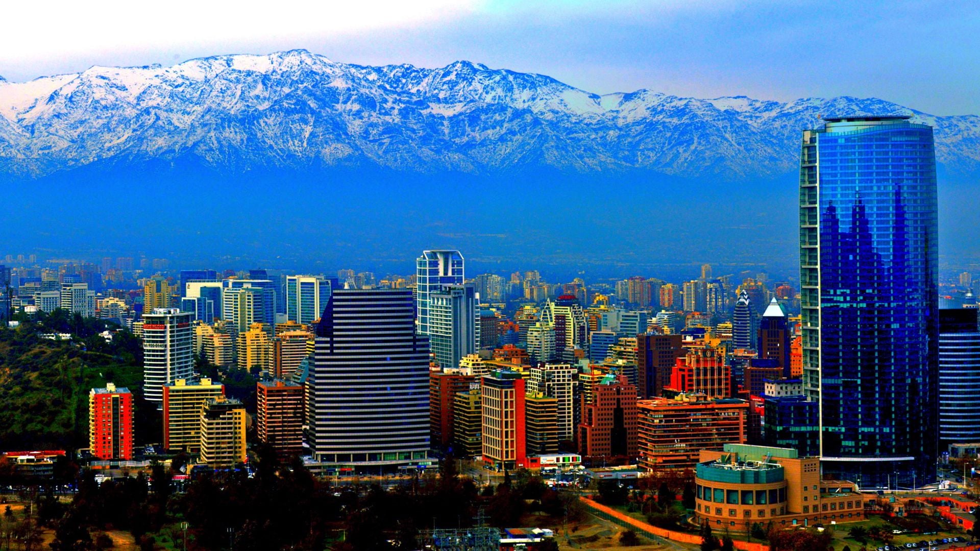 Skyline of Santiago, Chile, with glass towers in front of the snow-capped Andes.