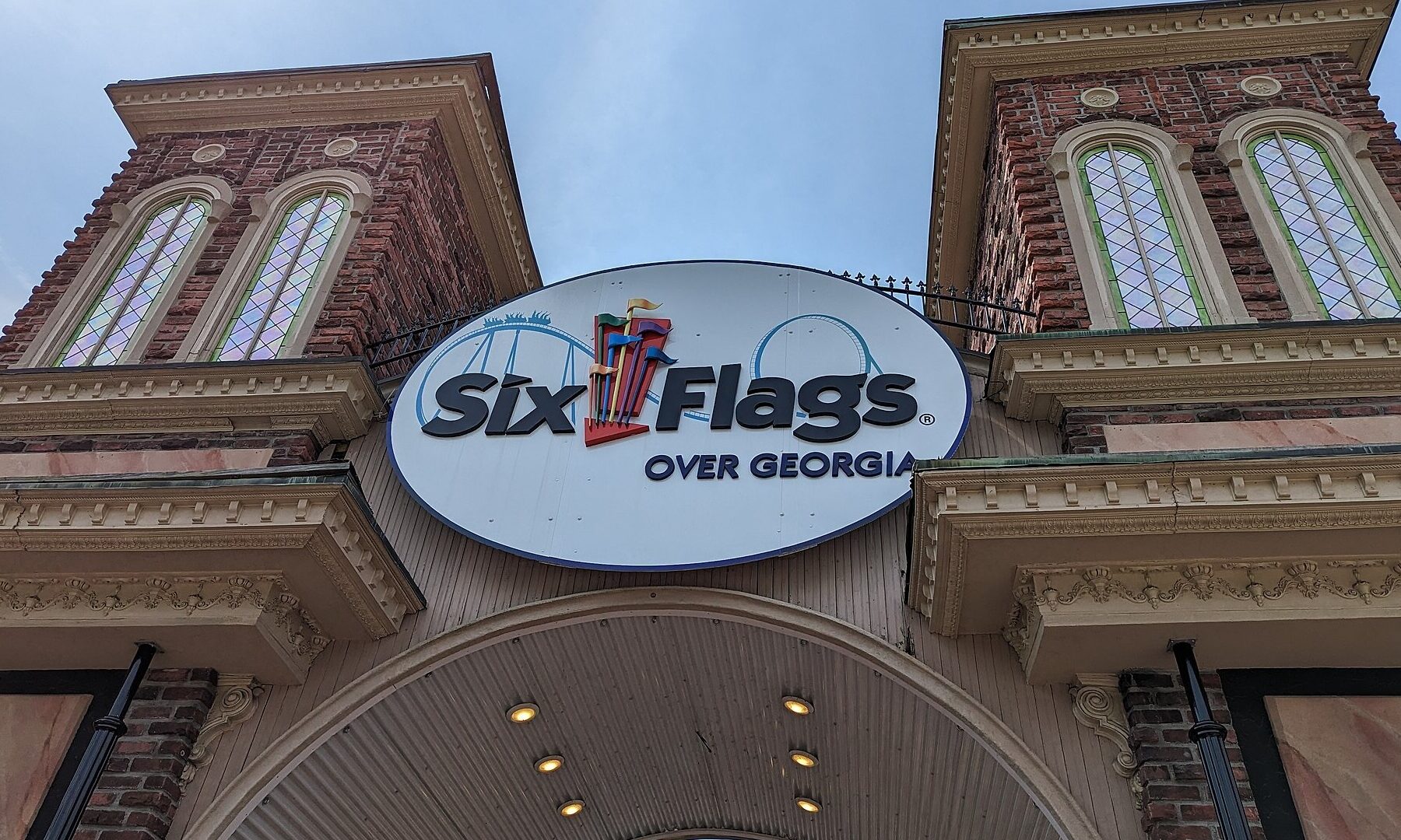 The entrance gate of Six Flags Over Georgia, with brick towers and the Six Flags Over Georgia sign above the arch