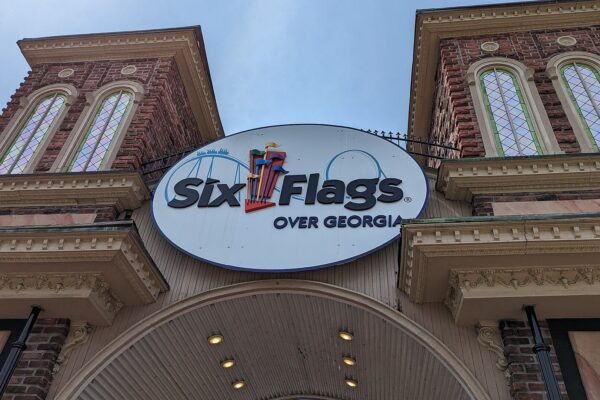 The entrance gate of Six Flags Over Georgia, with brick towers and the Six Flags Over Georgia sign above the arch
