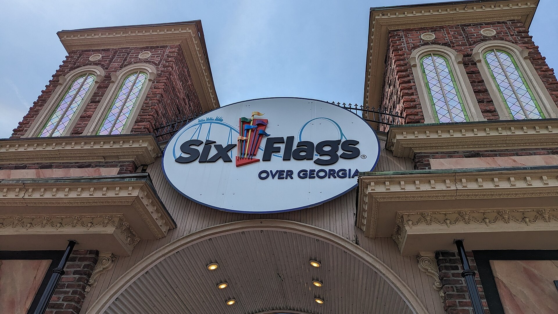 The entrance gate of Six Flags Over Georgia, with brick towers and the Six Flags Over Georgia sign above the arch