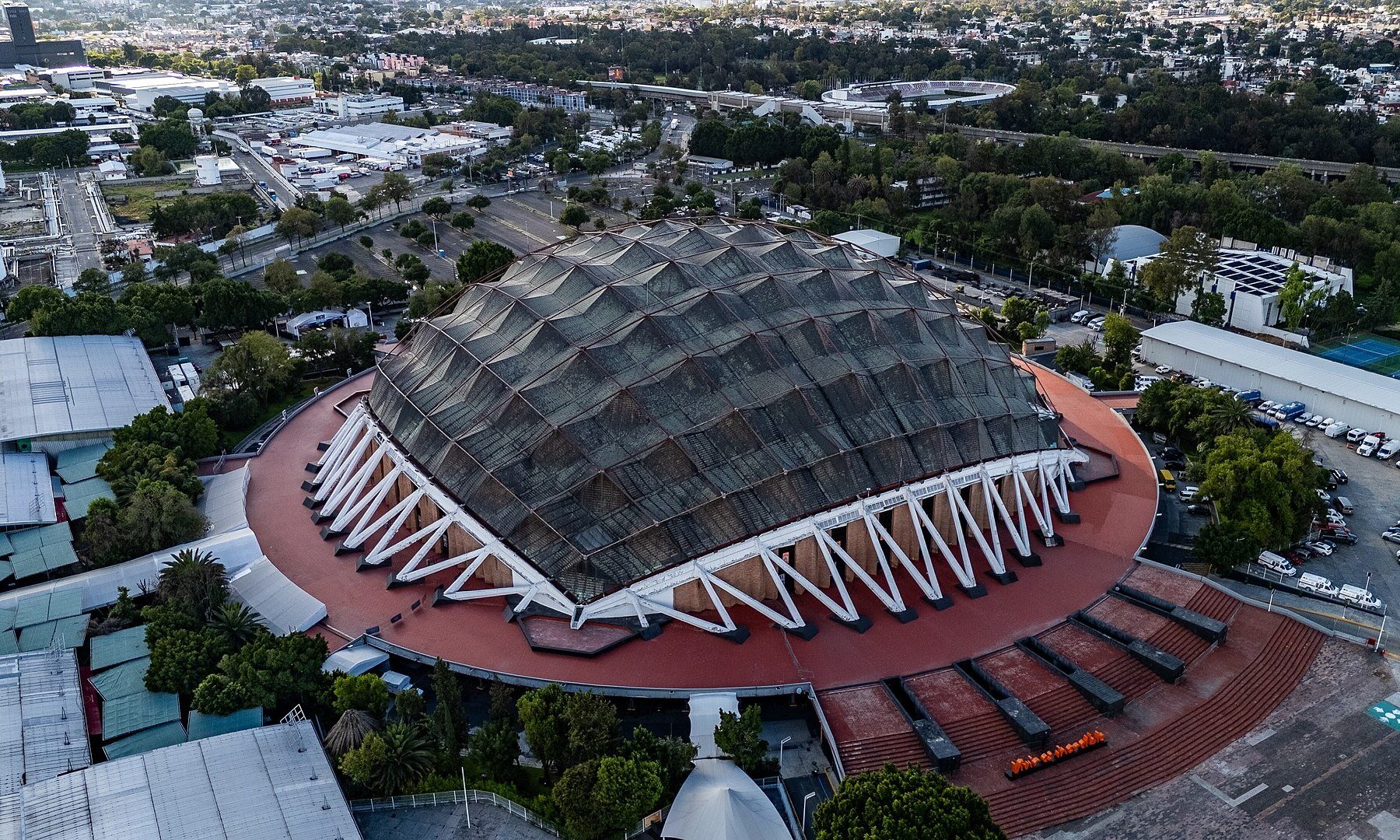 Aerial view of the copper-domed Palacio de los Deportes arena in Mexico City, where Soda Stereo plays on 23 November 2026