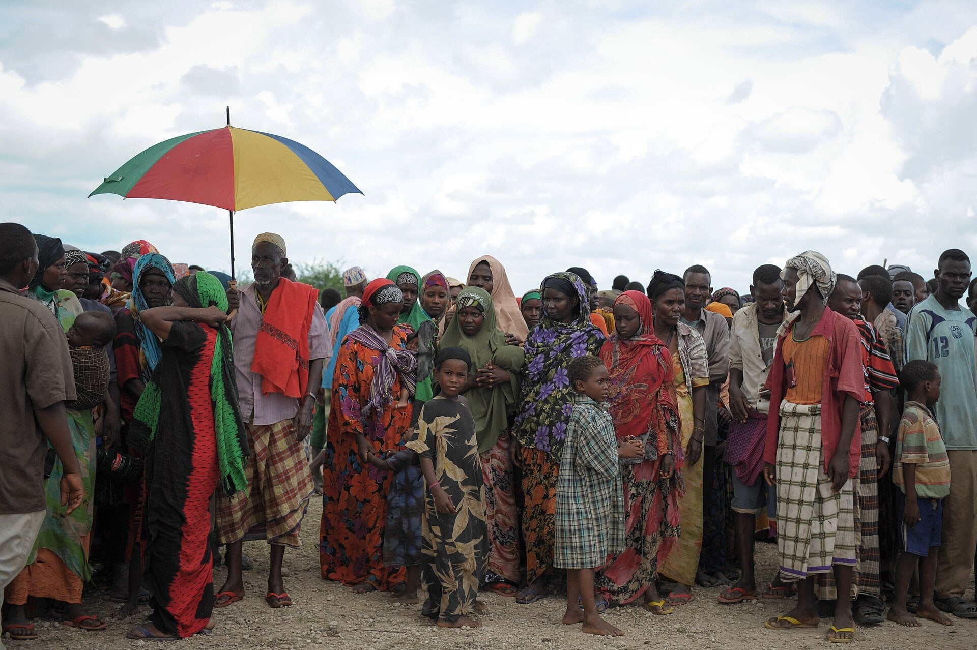 Displaced Somali families stand in a crowd near Jowhar in the Shabelle valley waiting for a food handout