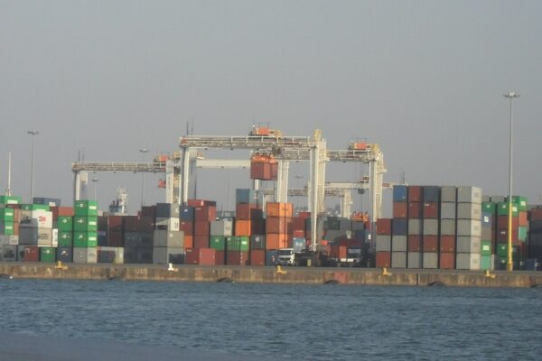 Stacked shipping containers and gantry cranes on a quay at the Port of Durban, South Africa.