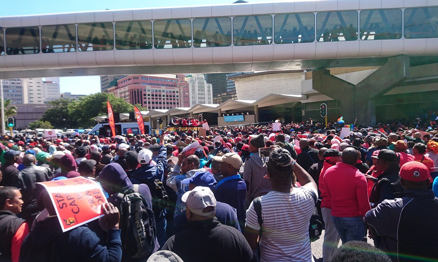 Cosatu members march in central Cape Town, South Africa, carrying orange Cosatu placards