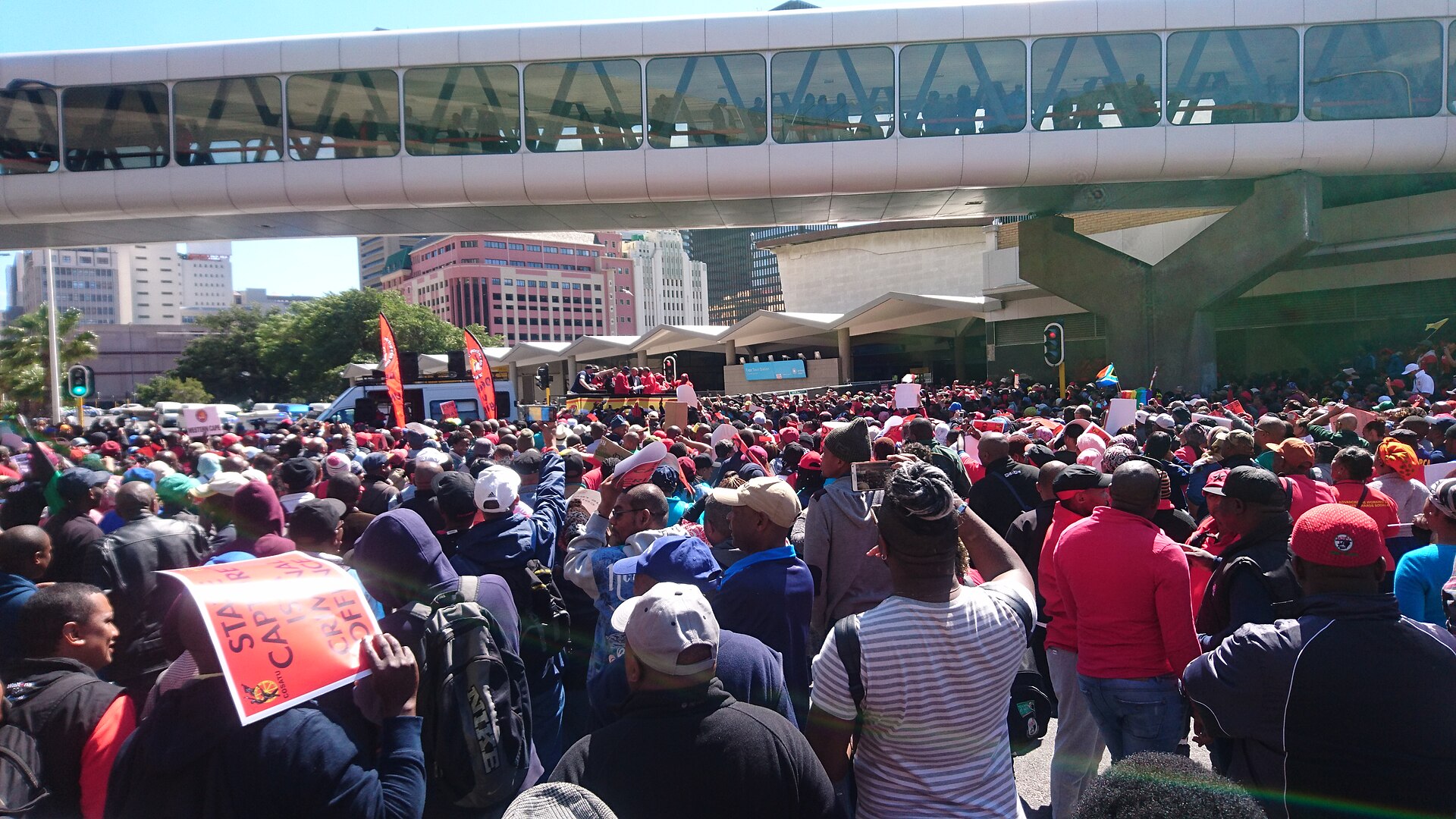 Cosatu members march in central Cape Town, South Africa, carrying orange Cosatu placards