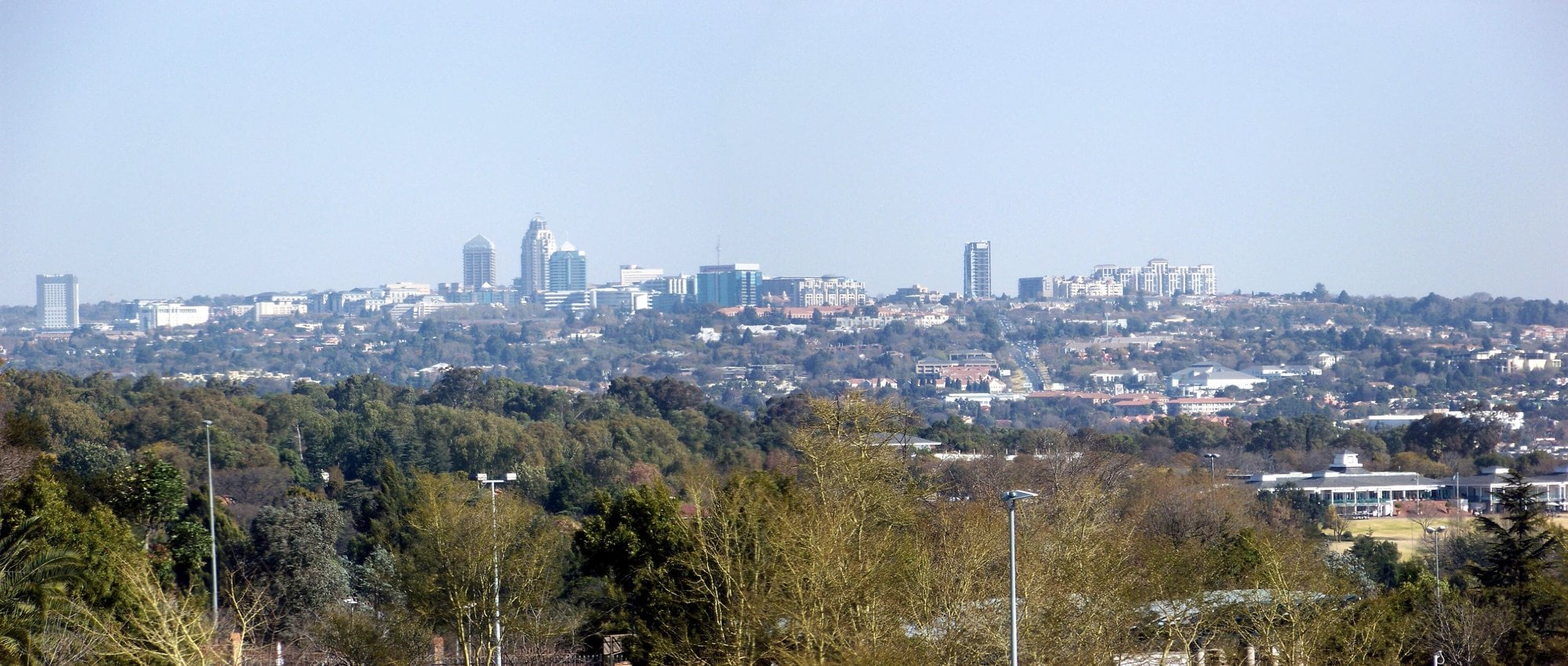 Sandton skyline in Johannesburg, South Africa, seen across wooded suburbs