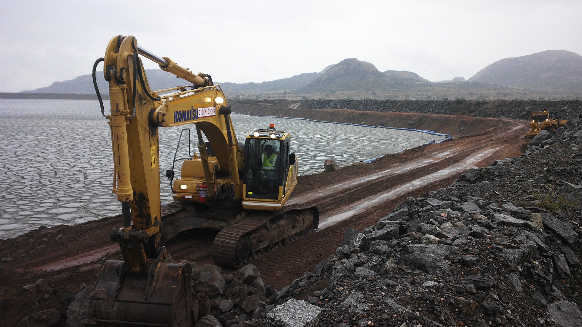 South Africa geopolitics and minerals: an excavator on a tailings wall at a platinum operation