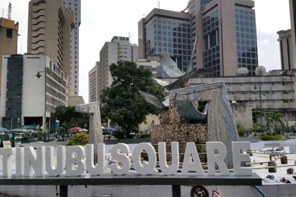 Tinubu Square in central Lagos, with its bird sculpture, white lettering and office towers behind