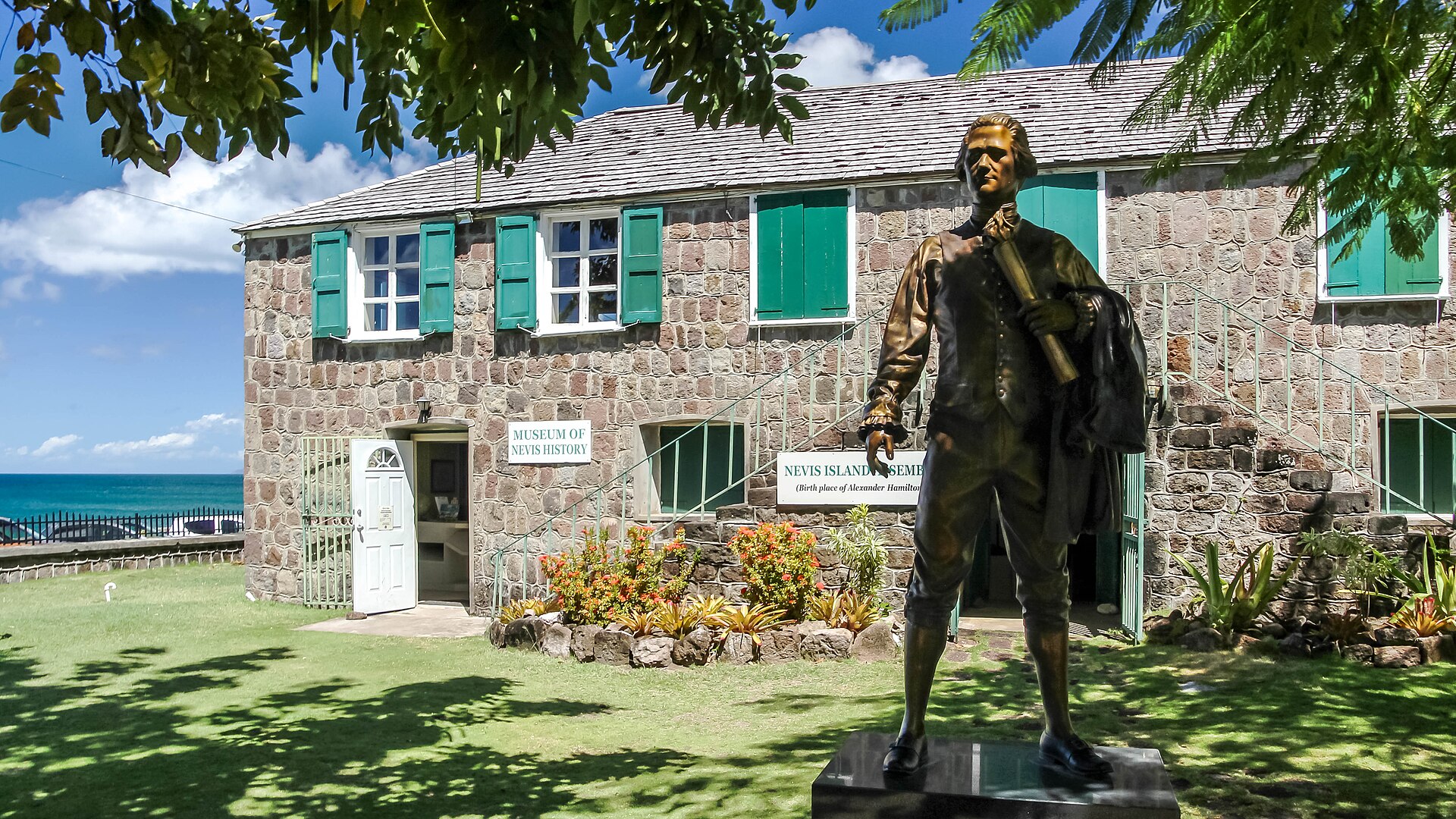 Museum of Nevis History in Charlestown with a bronze statue in front