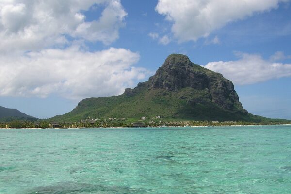 The Le Morne Brabant mountain rising above a turquoise lagoon on the south-west coast of Mauritius.