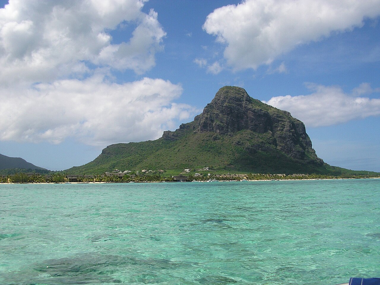 The Le Morne Brabant mountain rising above a turquoise lagoon on the south-west coast of Mauritius.