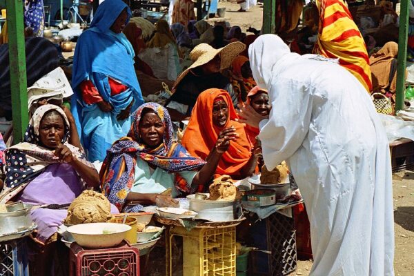Women sell food and tea at a busy market in Khartoum, Sudan, in a 2020 file photo.