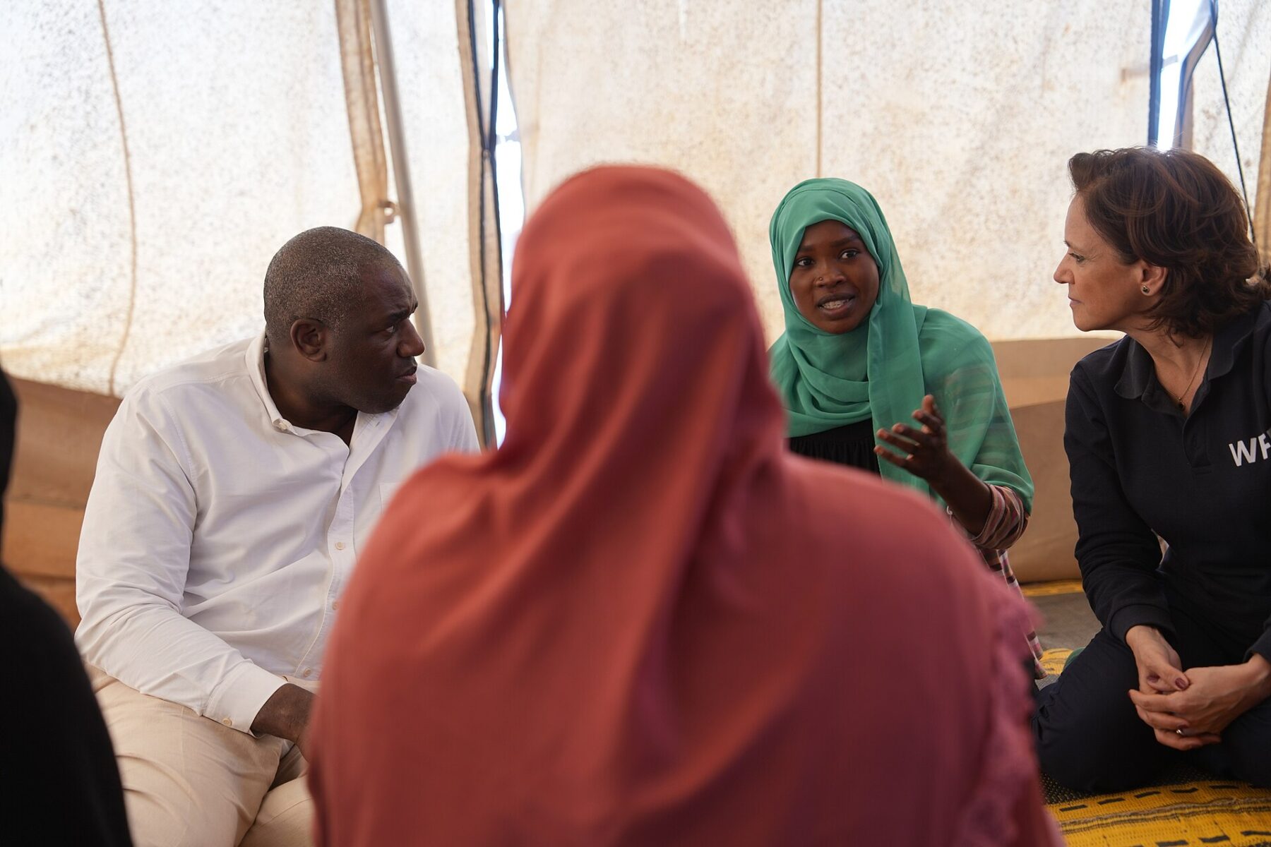 A Sudanese refugee woman speaks with visiting officials inside a tent in Adre, eastern Chad