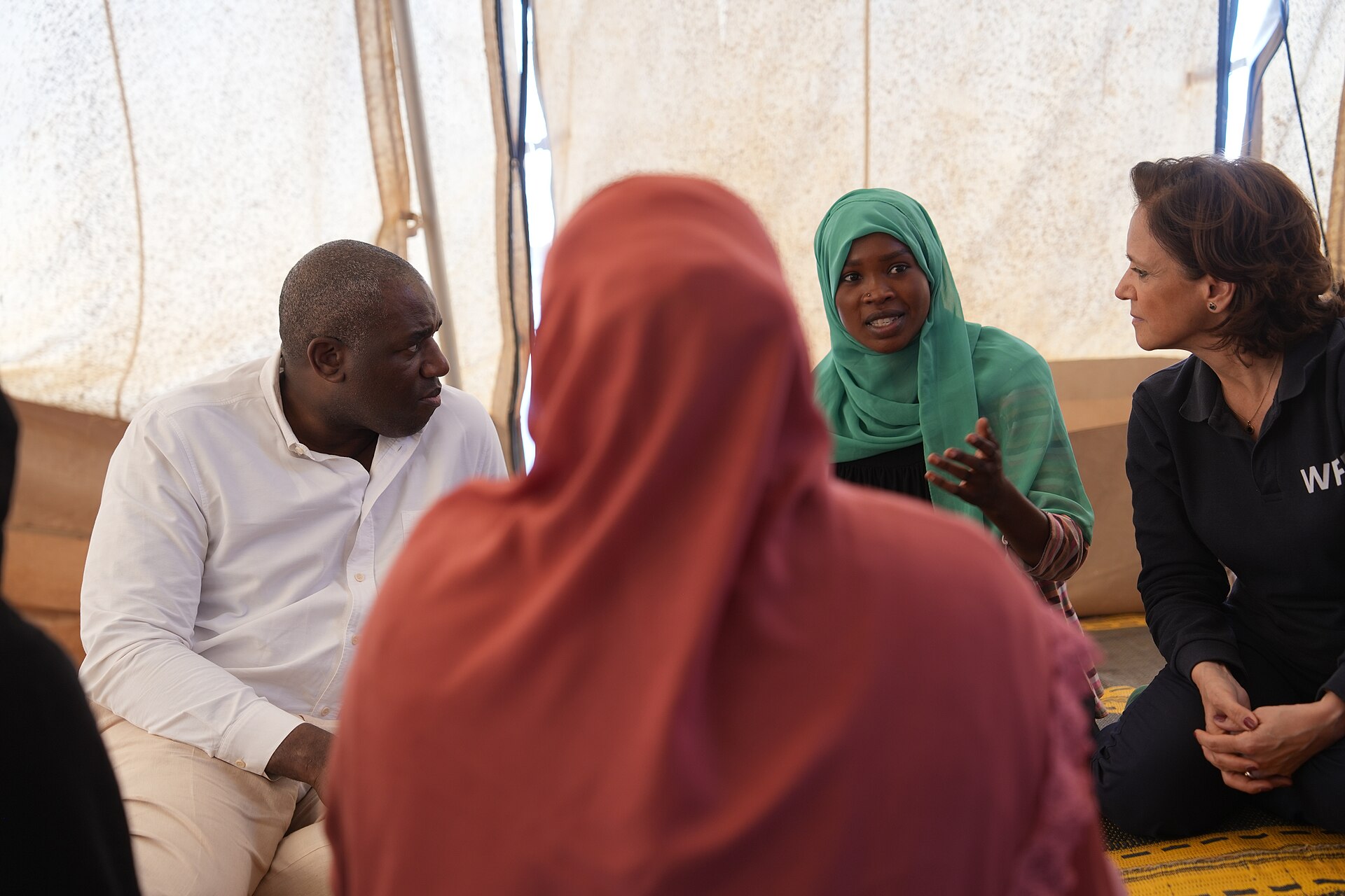 A Sudanese refugee woman speaks with visiting officials inside a tent in Adre, eastern Chad