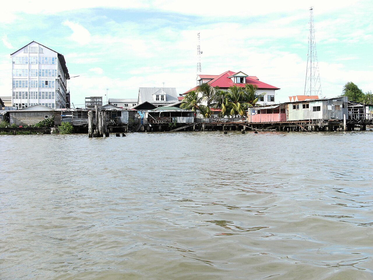 Buildings and a radio tower on the Paramaribo riverfront seen from the Suriname River