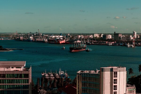 Ship leaving the harbour of Dar es Salaam with the container terminal, fuel tanks and grain silos along the far shore
